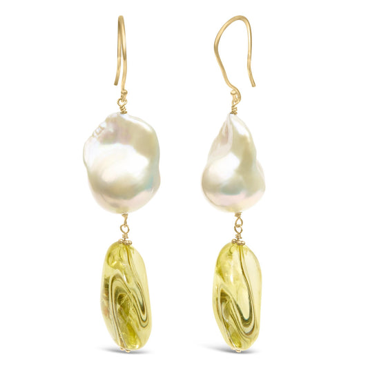 Front view of yellow metal earrings with irregular white and yellow gemstones hanging vertically.