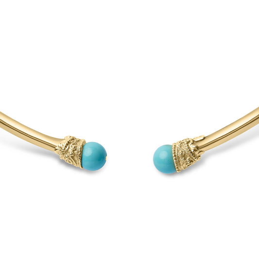 Close-up front angle of an open-ended yellow necklace with two round blue turquoise gemstones set in textured caps at each end.