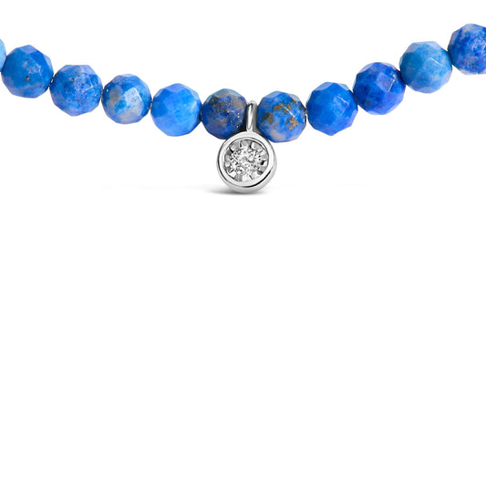 Close-up front view of a white metal necklace with faceted round blue gemstones and a small round white gemstone pendant in a miracle setting.