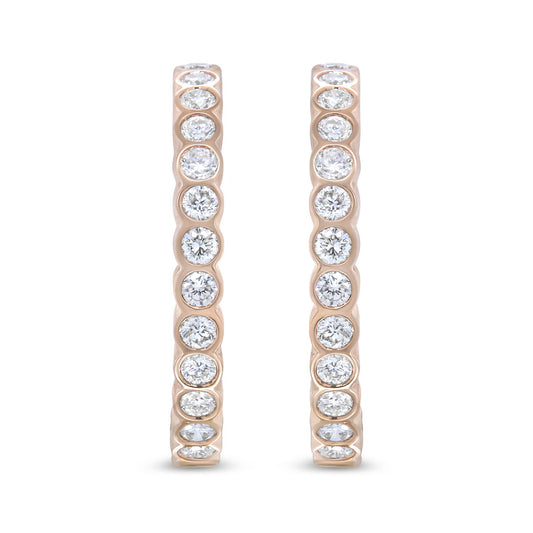 Front-facing close-up of a pair of rose-colored hoop earrings set with round white gemstones in bezel settings along the outer edge.