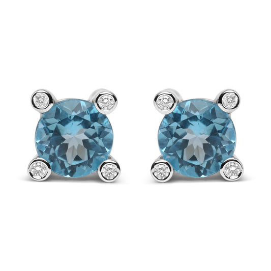 Front view of pair of white metal stud earrings with round blue gemstones prong set in the center and small round white gemstones bezel set at each corner.