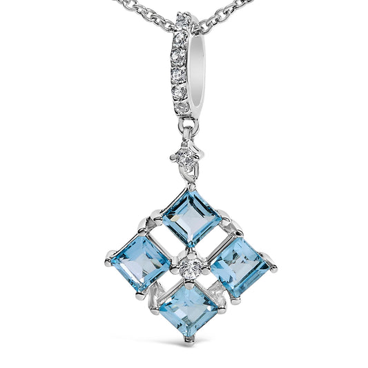 Close-up front view of a white metal necklace pendant featuring four blue square-shaped gemstones arranged in a diamond pattern with small white round gemstones interspersed, shown on a white background.