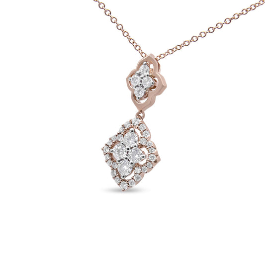 Close-up angled shot of a rose metal necklace with a pendant featuring clusters of round white gemstones set in shared prong settings.