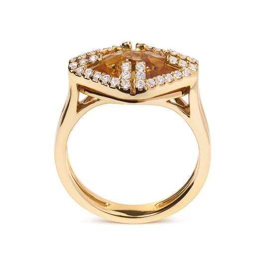 Front angle view of a yellow metal ring with a marquise-shaped yellow gemstone in the center, surrounded by a pave setting of round white gemstones.