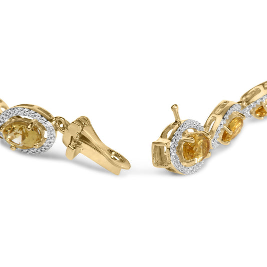 Close-up side angle of a yellow metal bracelet featuring oval yellow gemstones set with prongs, surrounded by white gemstones in a pave setting, shown on a white background.