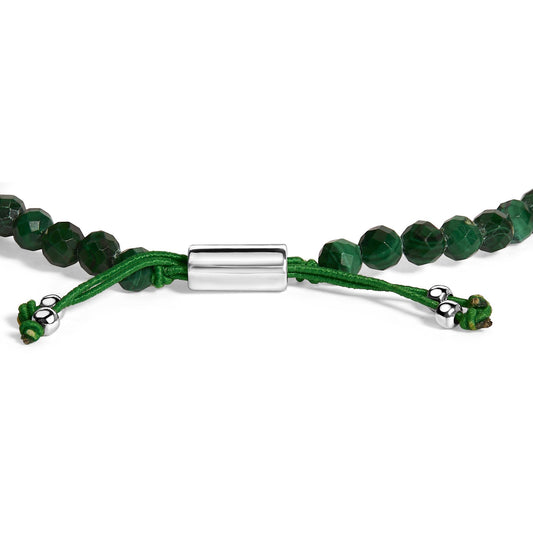 Close-up side angle of a white metal and green beaded bracelet with green cord and metal bead accents at the ends, shown flat on a white background.