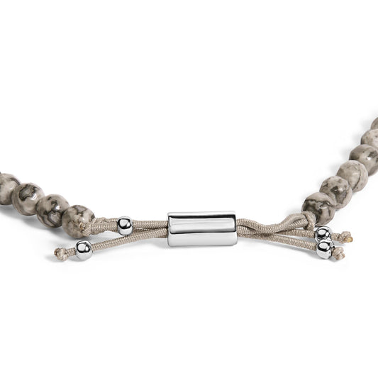 Close-up angled shot of a white metal clasp on a bracelet with marbled round beads and adjustable cord ends.