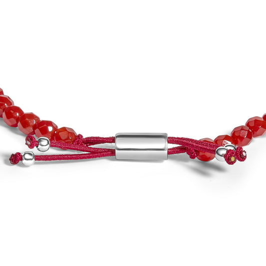 Close-up front view of a white metal cylindrical magnetic clasp bracelet with red cord and faceted red gemstones.
