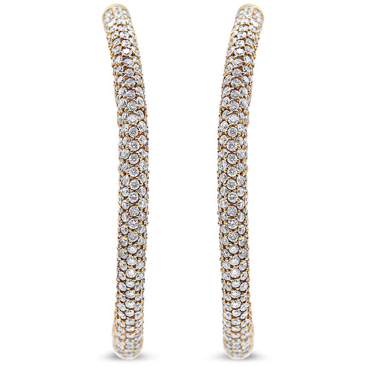 Close-up front view of a pair of rose-colored hoop earrings entirely covered with round white gemstones in pave settings.