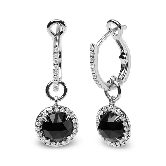 Front and side view of white metal drop earrings with round black gemstone surrounded by small white gemstones, showing prong settings.