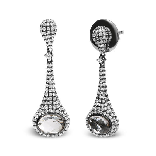 Pair of white and black metal drop earrings with a curved teardrop shape, pave-set round white gemstones, and bezel-set oval white gemstones, shown in a front-facing and slightly angled view.