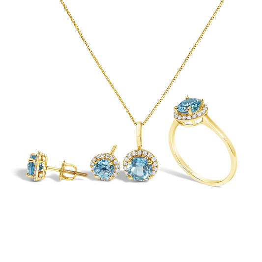 Set of yellow jewelry including a necklace with a pendant, a pair of stud earrings, and a ring, all featuring round blue gemstones surrounded by a circle of small white gemstones, shown from a front angle on a white background.