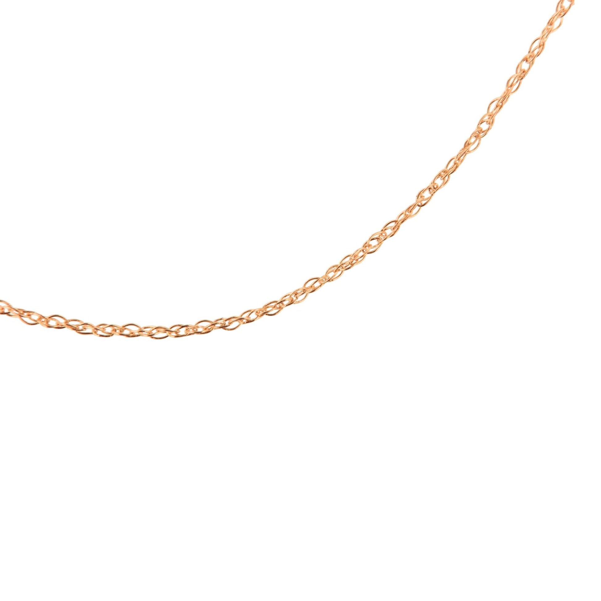 Close-up angle of a delicate rose-colored chain with small intertwined links on a white background.