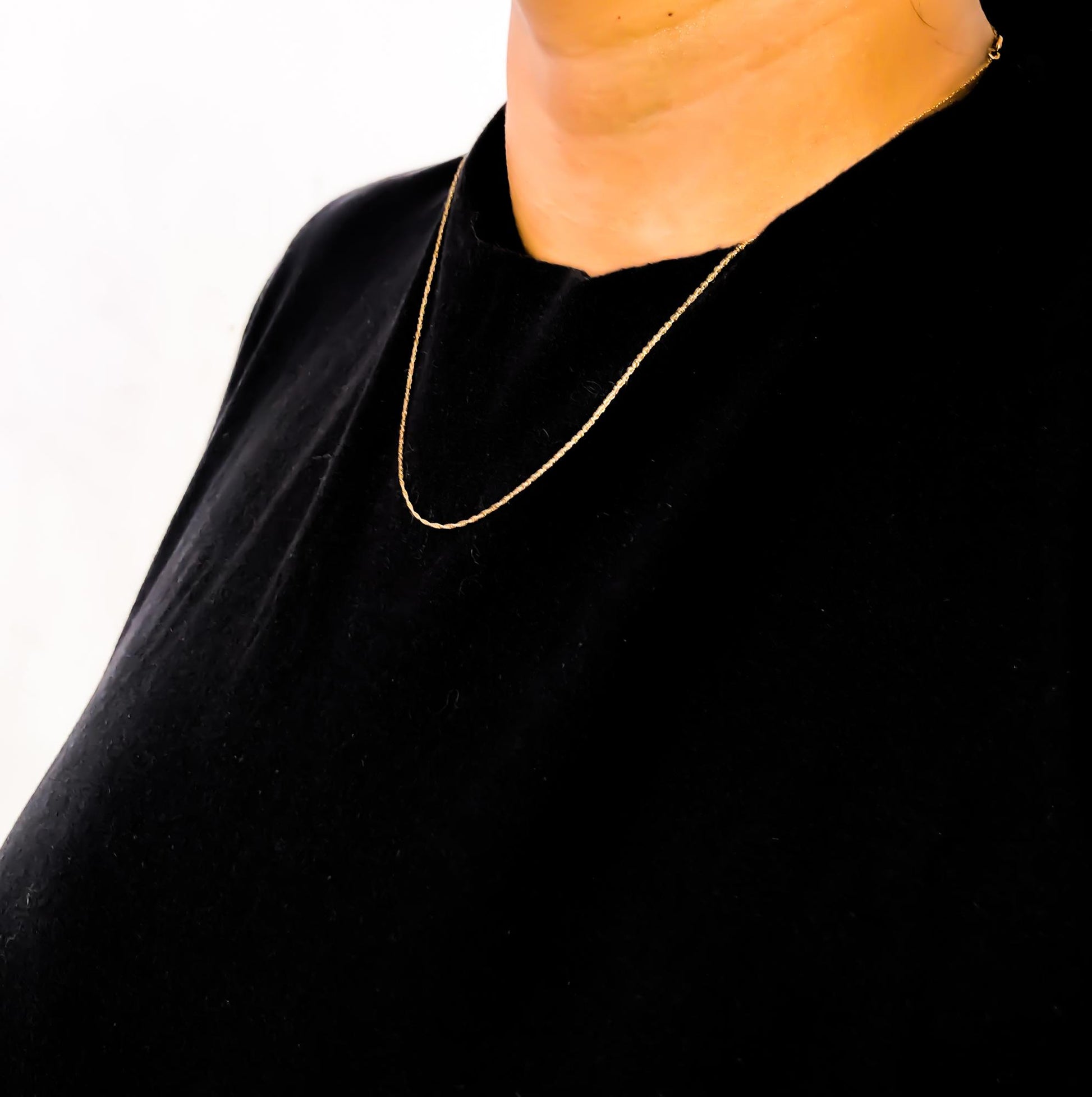 Yellow chain necklace shown worn on a model, front angle.