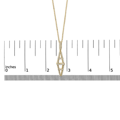 Yellow metal necklace with elongated geometric pendant featuring round white gemstones in pave setting, shown from front angle on ruler for size reference.