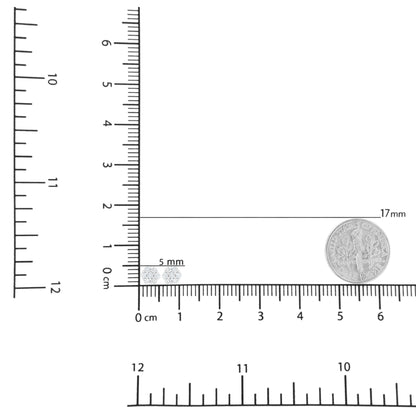 Top-down view of a pair of white metal stud earrings with round white gemstones in prong settings, displayed on a ruler for size reference.