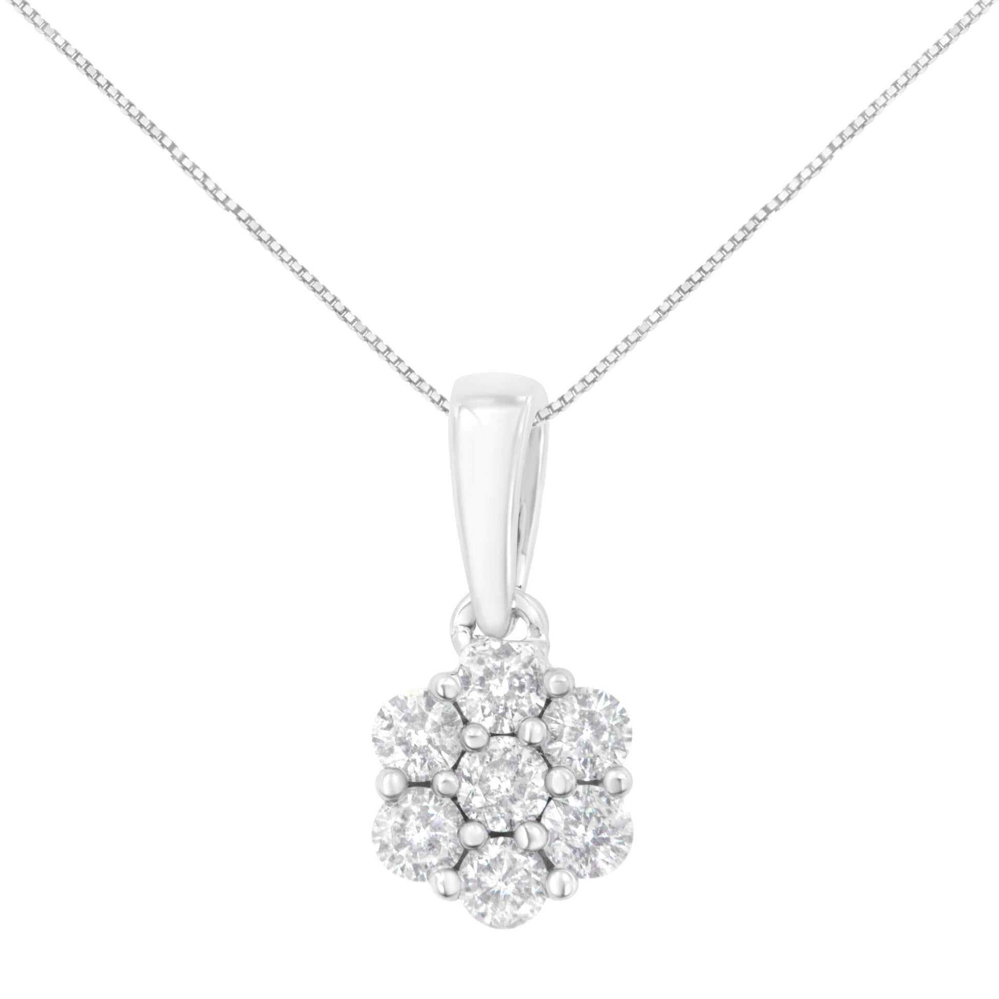 Front view of a white metal necklace with a flower-shaped pendant featuring round white gemstones in prong settings.