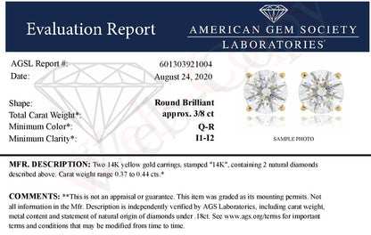 Pair of yellow metal stud earrings with round white gemstones in four-prong settings, shown from a front angle.