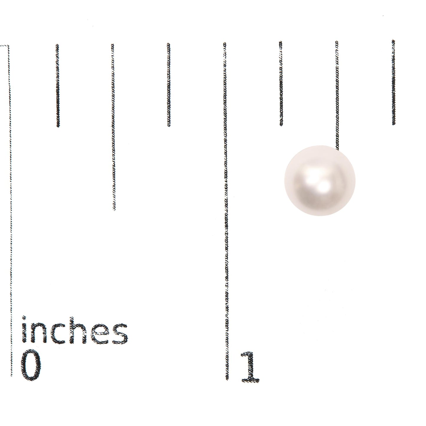 Single round white gemstone earring on a ruler for size reference, top-down angle.