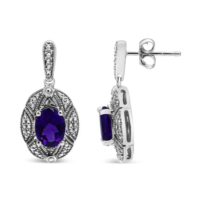 Pair of white metal earrings with oval purple gemstones and round white gemstones in prong settings, shown from front and side angles.
