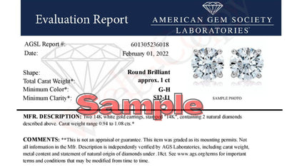 Close-up front view of a pair of white metal stud earrings, each set with a single round white gemstone in a four-prong setting, shown on a white background.