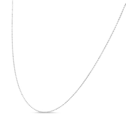 Close-up front view of a delicate white metal beaded chain against a white background.