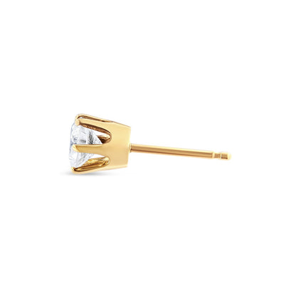 Side angle view of a yellow metal stud earring featuring a single round white gemstone in a six-prong setting.