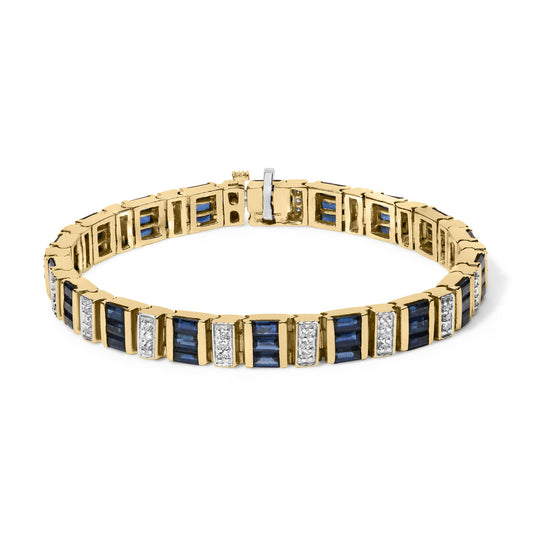 Yellow bracelet with alternating blue baguette-shaped gemstones in channel settings and sections of round white gemstones in shared prong settings, shown from a front angle.