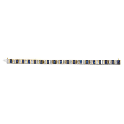Straight-on view of a yellow metal bracelet featuring alternating round white gemstones in shared prong settings and blue baguette-shaped gemstones in channel settings.