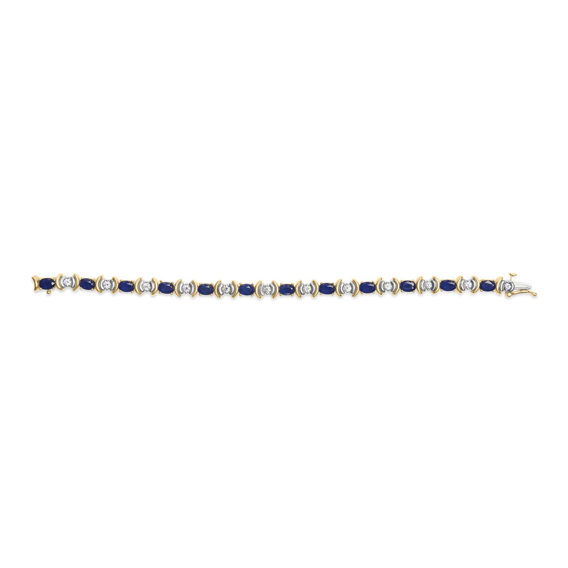 Yellow metal bracelet with alternating oval blue gemstones and round white gemstones, shot from above on a white background.