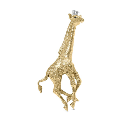 Front angled view of yellow metal giraffe-shaped brooch with textured details, adorned with white round gemstones on the crown and blue round gemstones for the eyes.