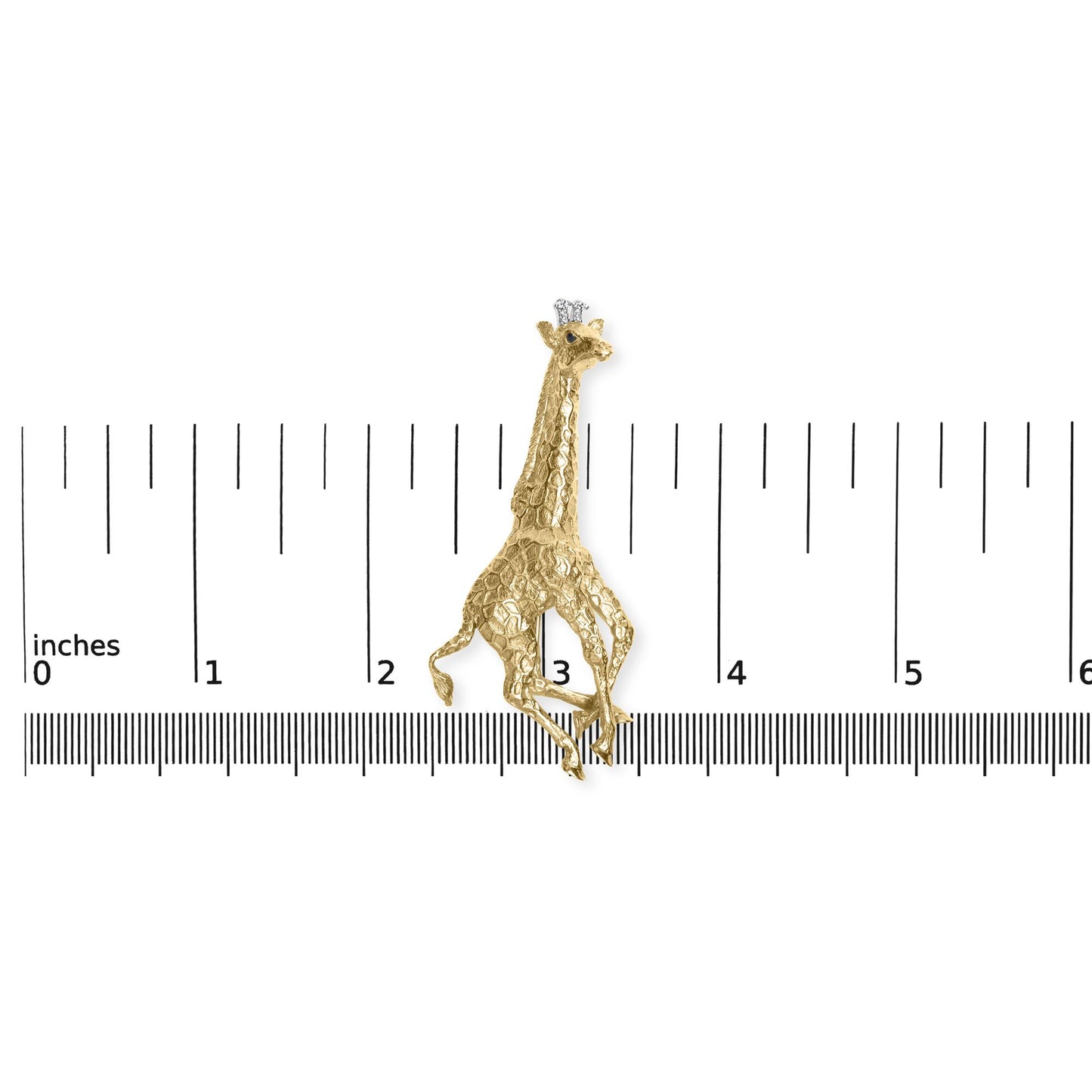 Close-up front angle of a yellow giraffe-shaped brooch with textured detail, adorned with round white gemstones in a shared prong setting on the giraffe's head, and round blue gemstones in bezel settings on the crown and eyes, placed on a ruler for size reference.