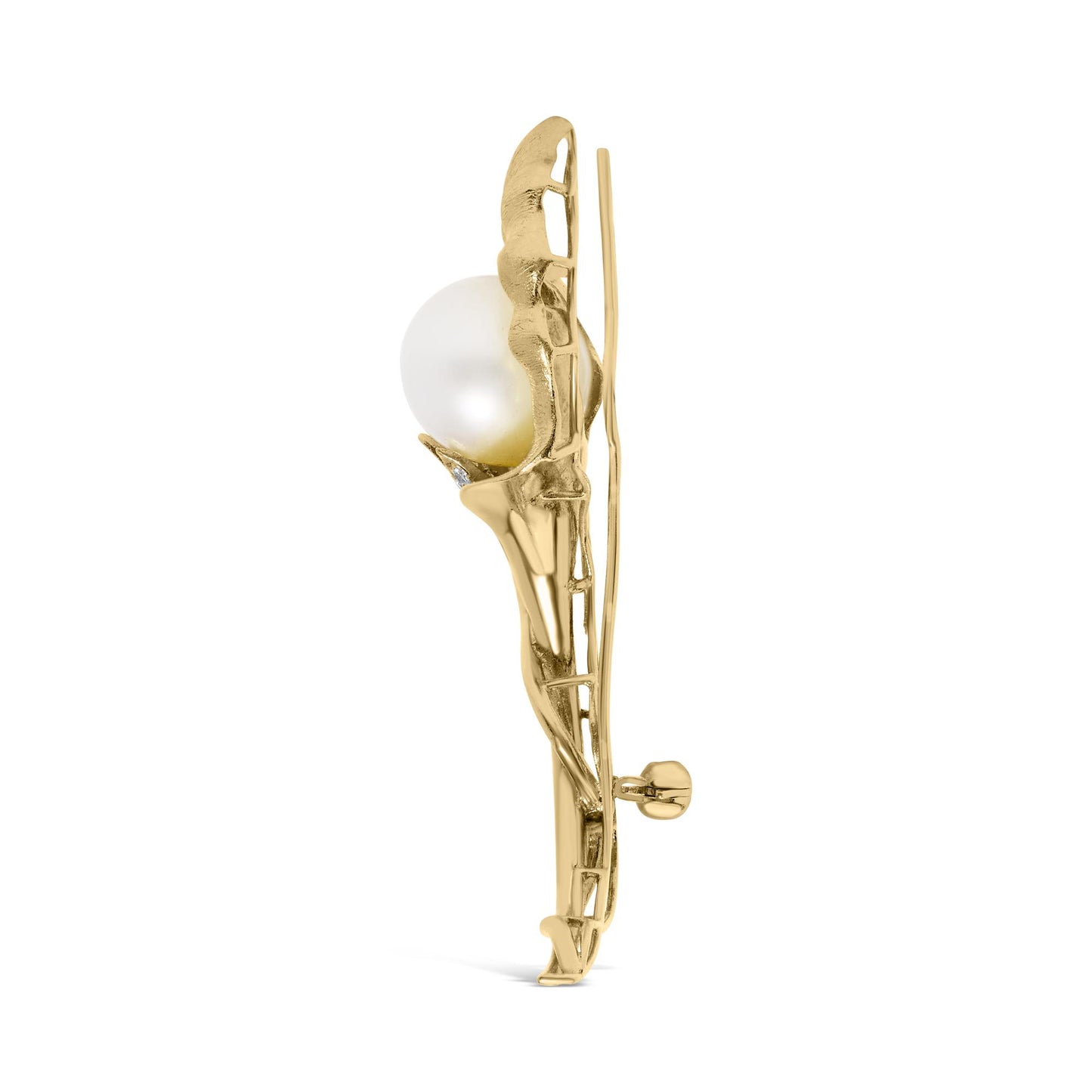 Side view of a yellow metal brooch with a large white pearl and small white gemstones in pave setting.