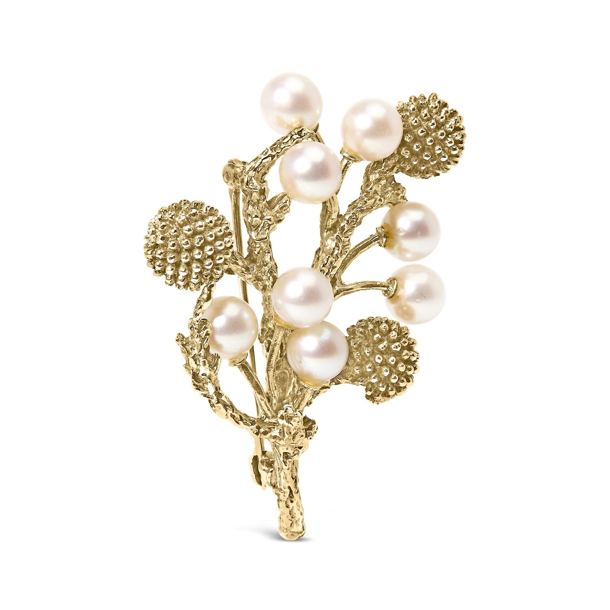 Yellow metal brooch designed as textured branches with round clusters and white round gemstones, shown from a front angle.