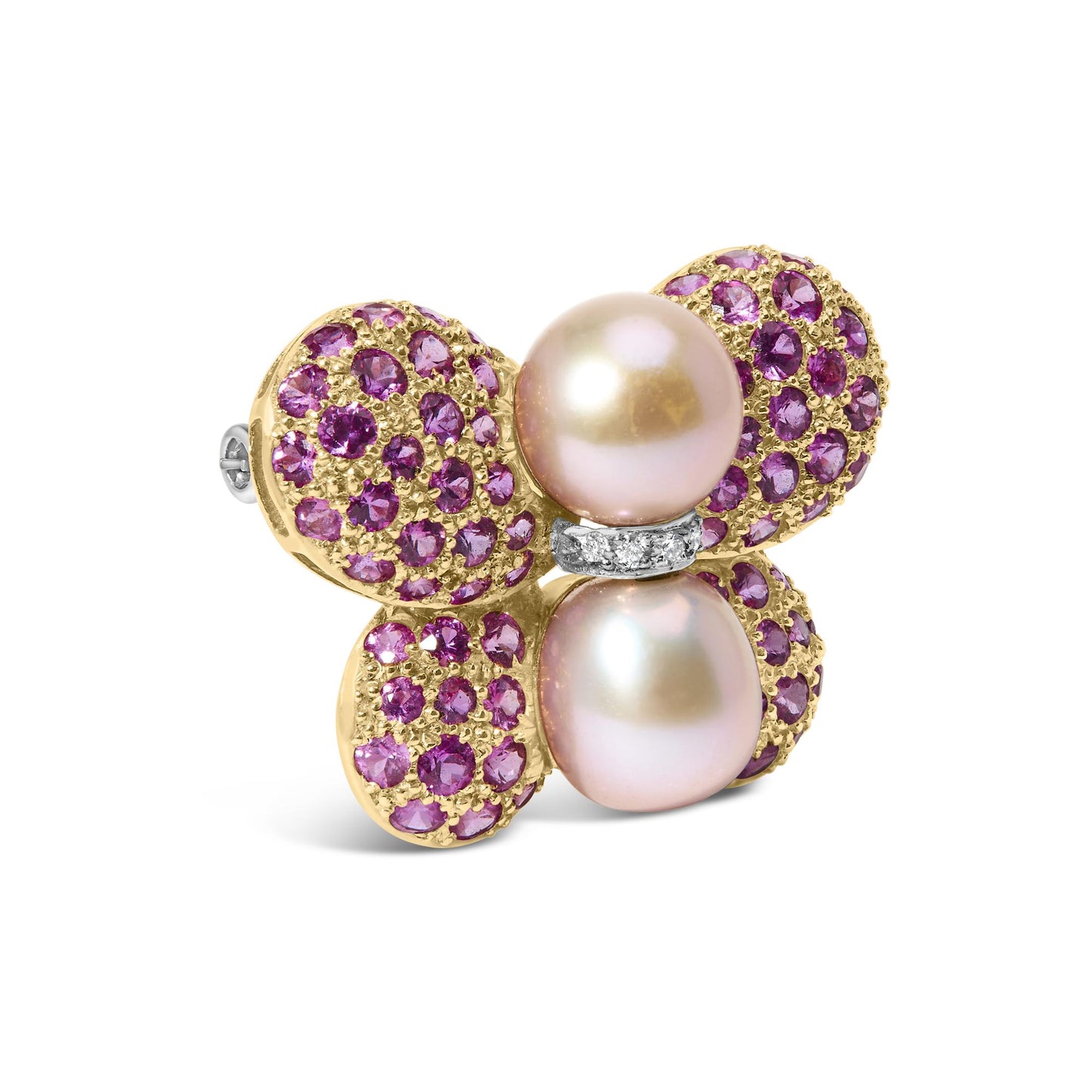Close-up angle of a yellow and white metal brooch shaped like a flower with four rounded petals adorned with pink round gemstones in pave setting, two large pearls at the center, and a small band with white round gemstones between the pearls.