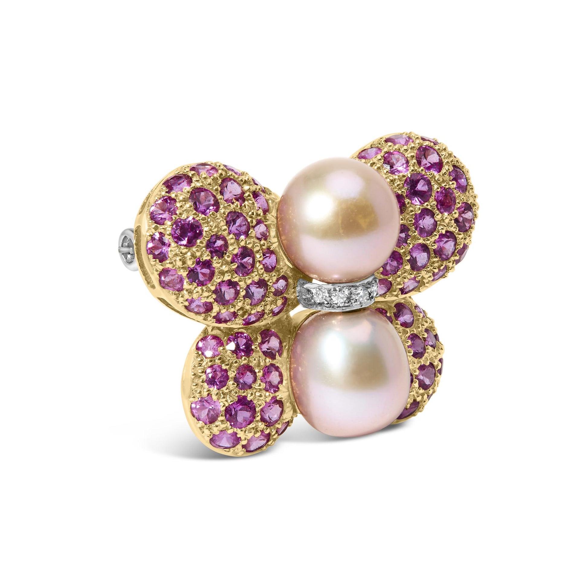 Close-up angle of a yellow and white metal brooch shaped like a flower with four rounded petals adorned with pink round gemstones in pave setting, two large pearls at the center, and a small band with white round gemstones between the pearls.