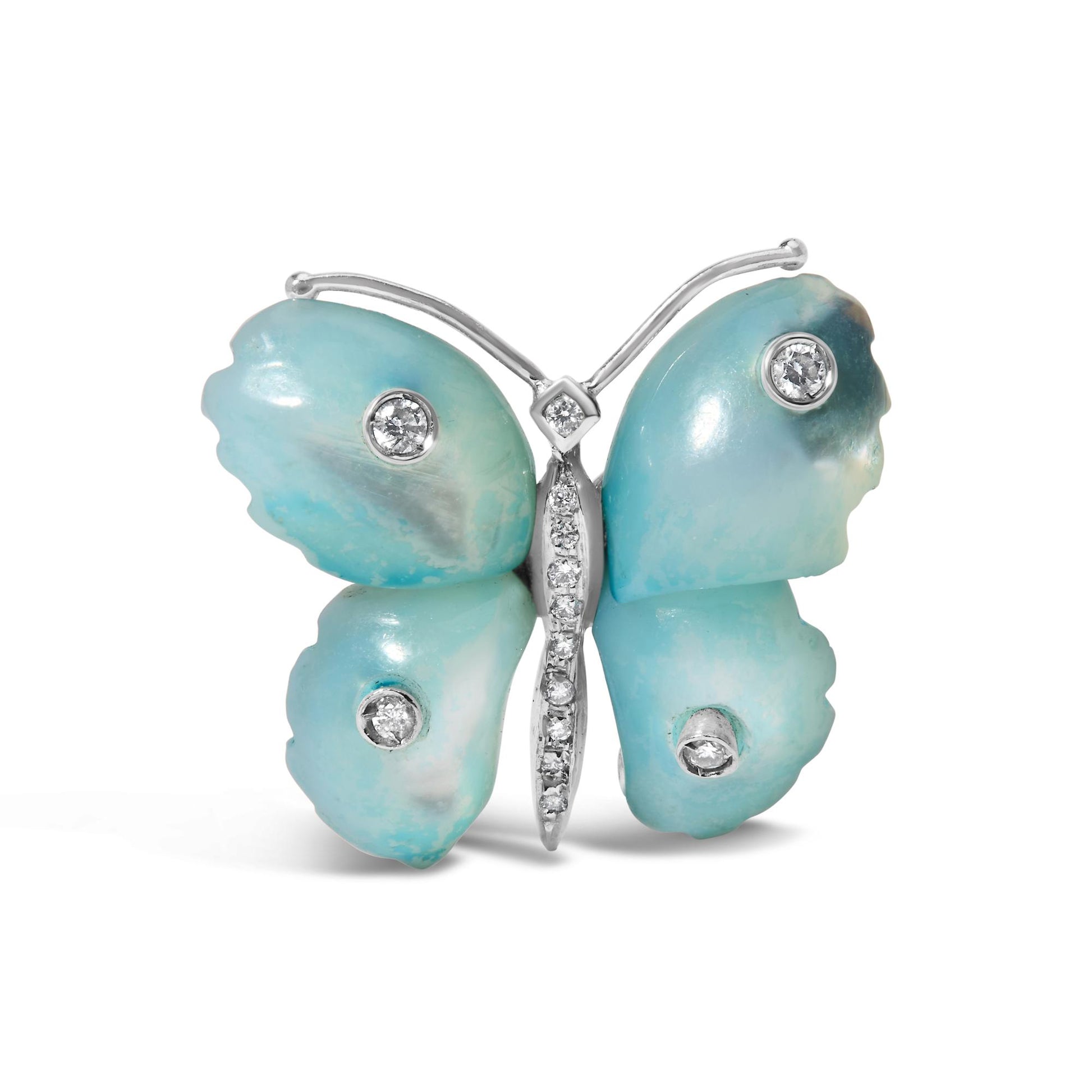 Front-facing image of a butterfly-shaped brooch with white metal edges. The wings have smooth, rounded shapes with blue stones, each decorated with bezel-set white gemstones. The body features a vertical line of pave-set white gemstones in the center. The brooch is shown on a white background.