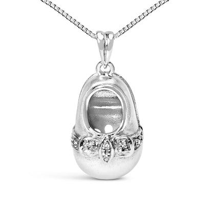 White metal necklace with an oval-shaped pendant featuring a cut-out center and a band of round white gemstones in 4-prong settings across the front, shown in a front-facing close-up shot.