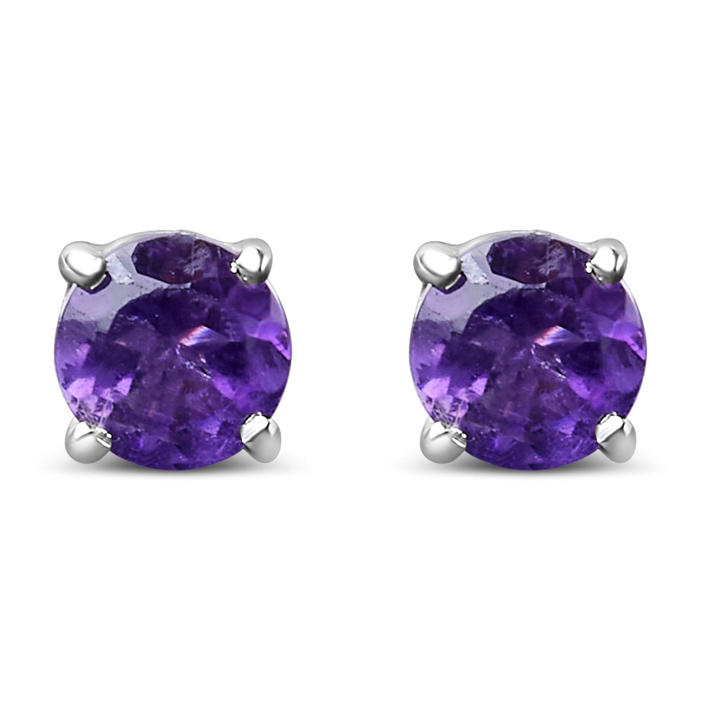 Close-up front view of a pair of white metal stud earrings with round purple gemstones held by four prongs.