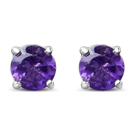 Close-up front view of a pair of white metal stud earrings with round purple gemstones held by four prongs.