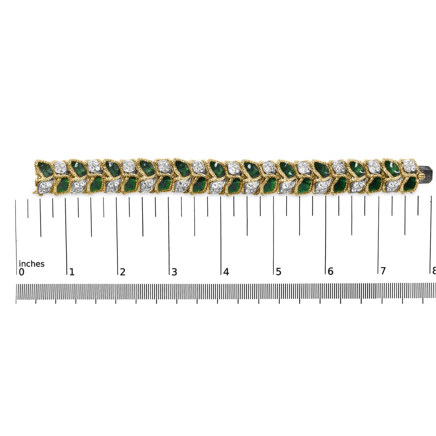 Yellow metal bracelet with alternating green and white gemstones in a leaf design, shown from above on a ruler for size reference.