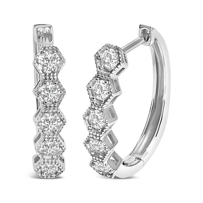 Close-up front and side angle of white metal hoop earrings featuring round white gemstones in six-prong settings along the front outer edge.