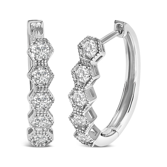 Close-up front and side angle of white metal hoop earrings featuring round white gemstones in six-prong settings along the front outer edge.