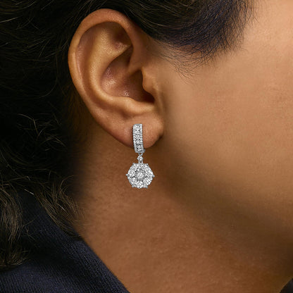 Close-up side view of a white metal drop earring with white round gemstones in prong, channel, and miracle settings, shown worn on a model.
