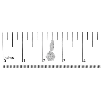 White metal earring with a round cluster of white gemstones in prong setting hanging from a rectangular section adorned with channel and prong set white gemstones, shown on a ruler scale from a front angle.