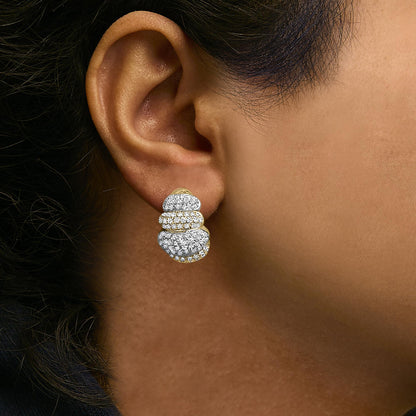 Close-up side view of a model wearing a layered cluster earring featuring yellow and white metal colors with round white gemstones in pave setting.