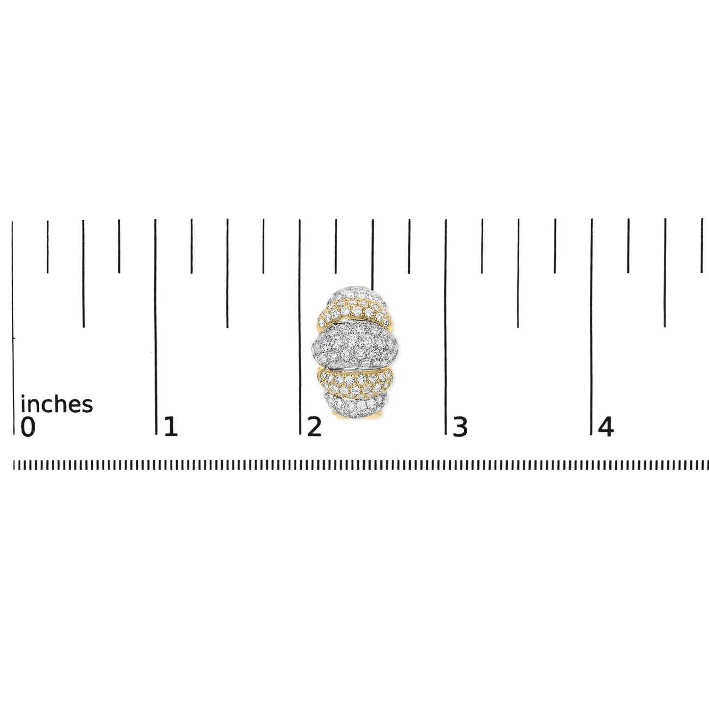Close-up top view of a rounded earring with alternating yellow and white areas, pavé set with numerous small white gemstones, shown on a ruler for scale.