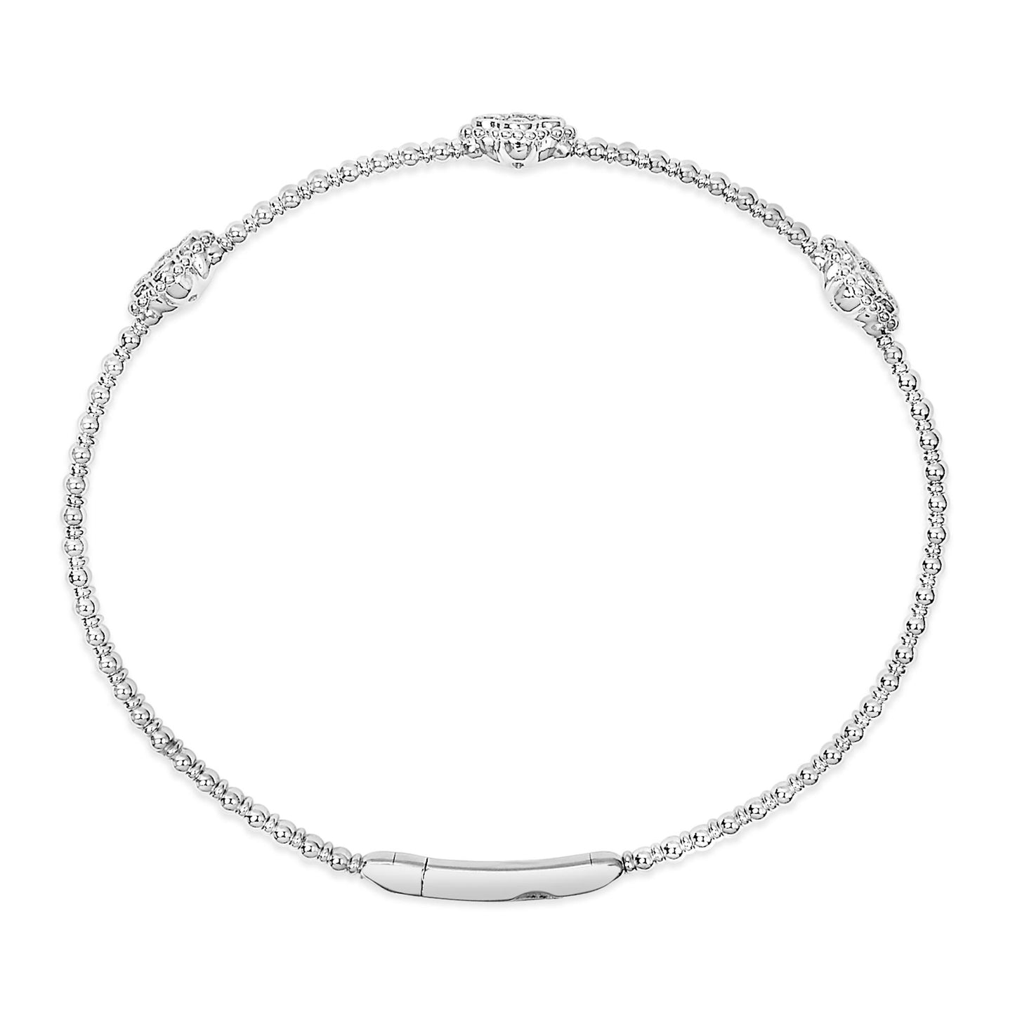 White metal bracelet with round white gemstones in shared prong settings, shown in a top-down view.