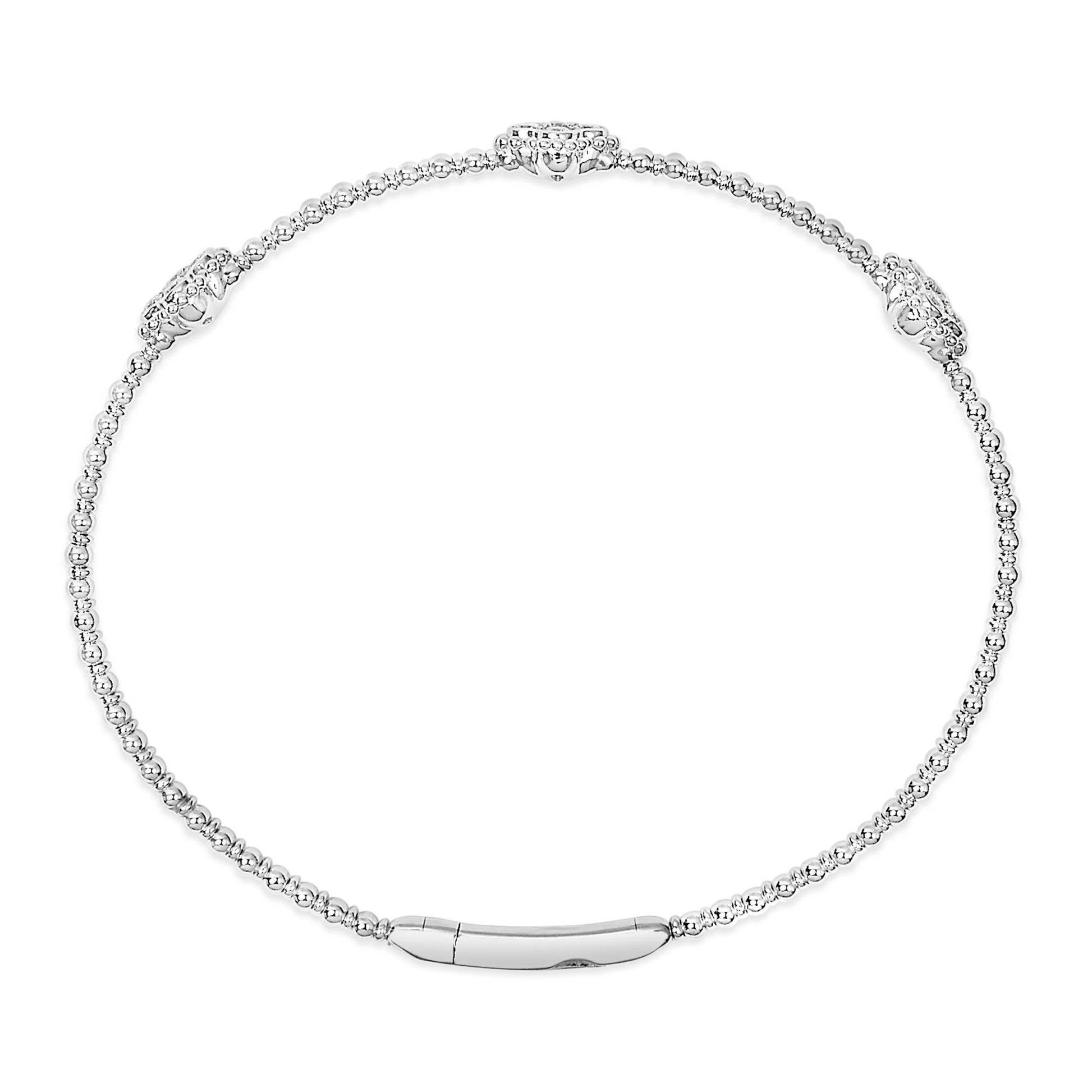 White metal bracelet with round white gemstones in shared prong settings, shown in a top-down view.