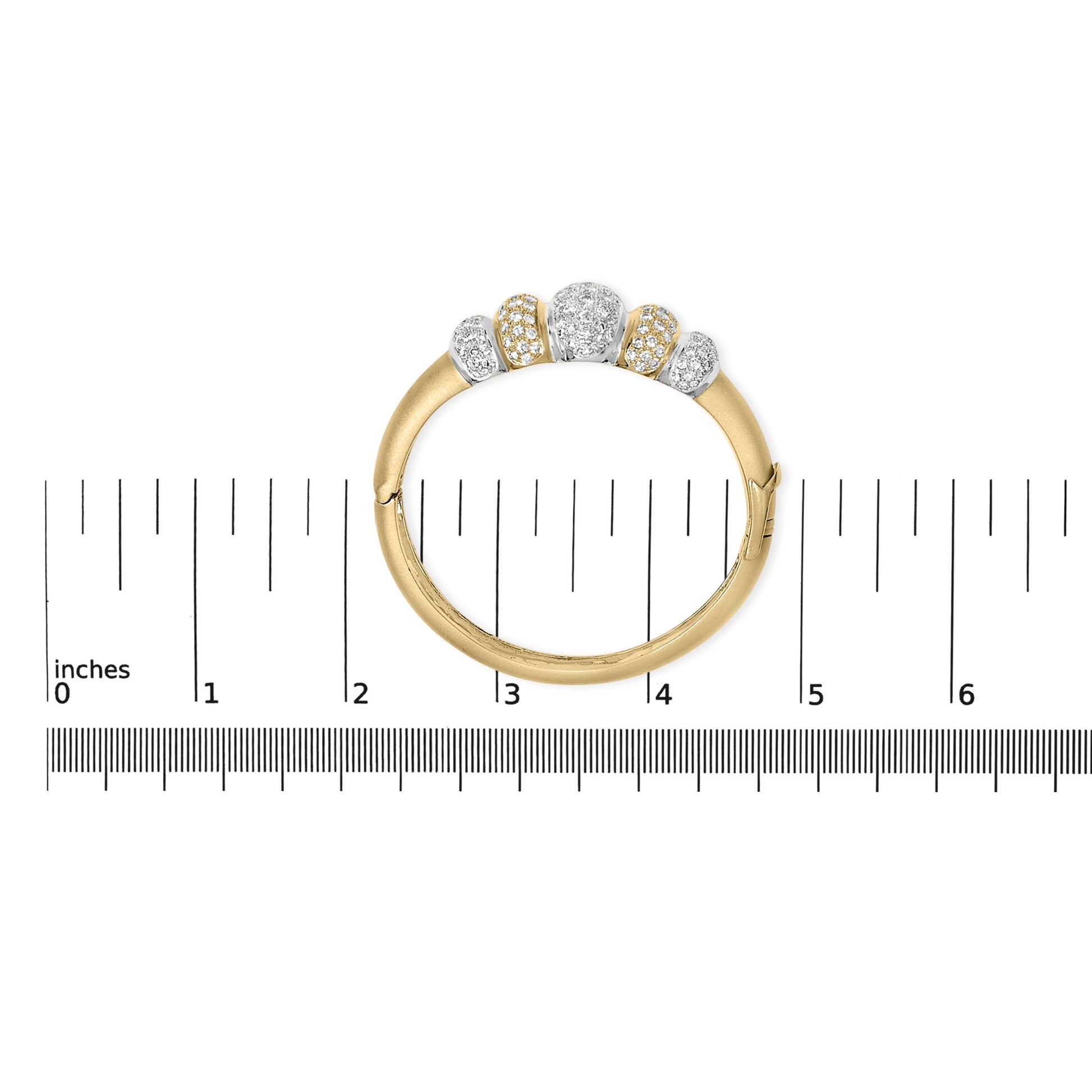 Bracelet in yellow and white metal with five sections set with round white gemstones in pave setting, shown flat on a measuring scale from top view.